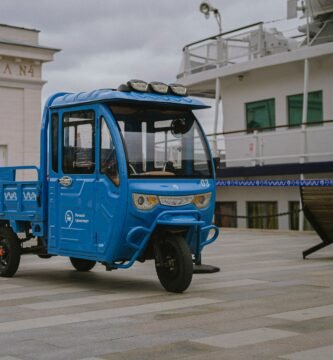 a small blue truck parked in front of a building